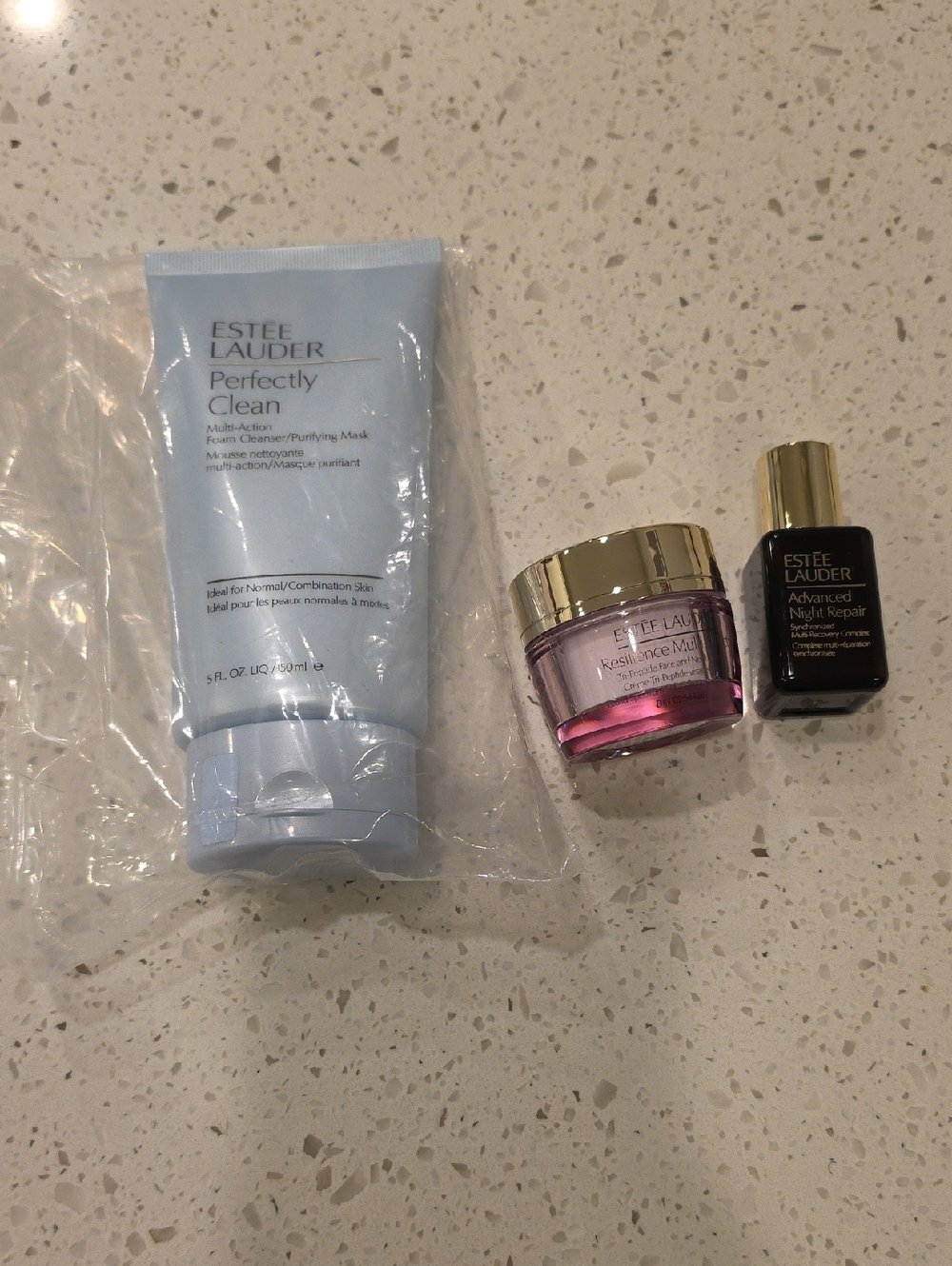 Estee Lauder skincare trio in light blue, pink and black